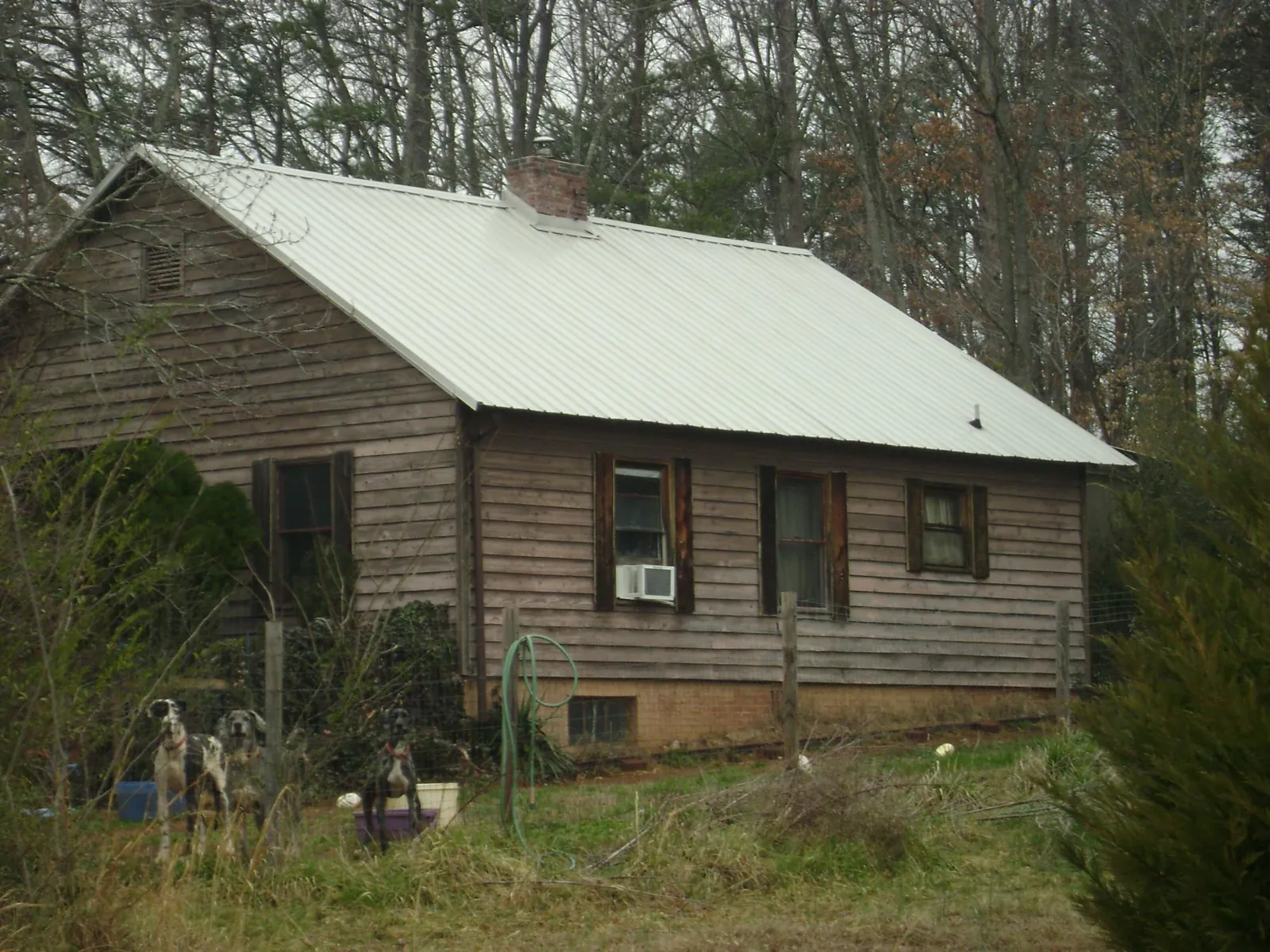 White metal roof on an old wood sided farmhouse, from a Metal Roof Installation job in Callao